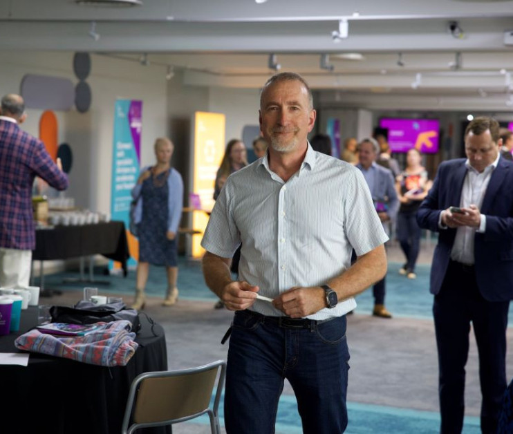 man with pen ad a trade show venue in Solihull